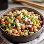 Mixing dense bean salad with vinaigrette